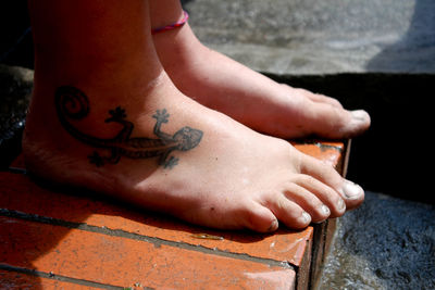 Low section of man sitting outdoors