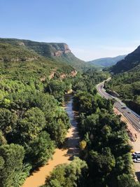 High angle view of river amidst trees against sky