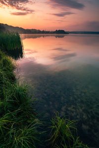 Scenic view of lake against sky during sunset