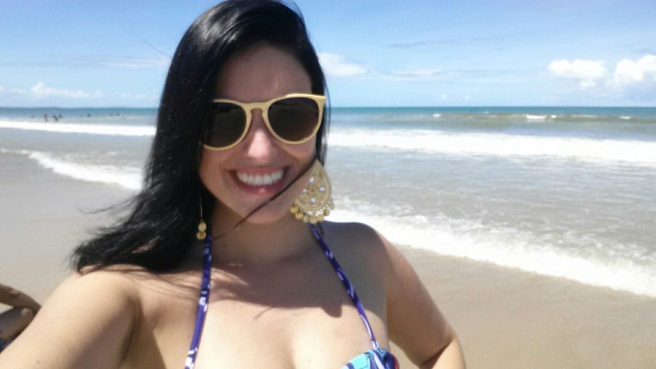 beach, sea, person, portrait, sunglasses, young adult, water, looking at camera, young women, lifestyles, leisure activity, horizon over water, shore, vacations, sand, smiling, sky, headshot