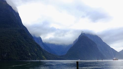 Scenic view of lake and mountains against sky