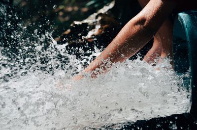 Close-up of hand splashing water