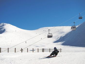 Person snowboarding on snowcapped mountains