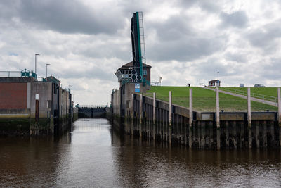 River amidst building against sky