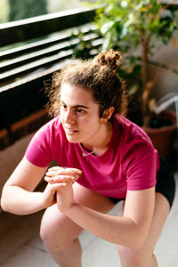Portrait of a young woman sitting outdoors