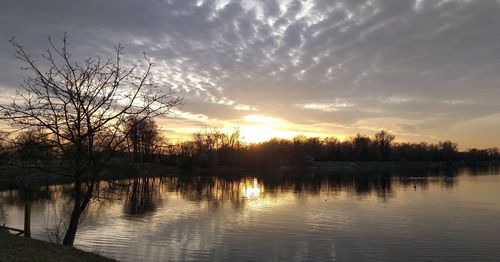 Scenic view of lake against sky during sunset