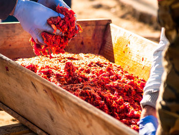 Midsection of man preparing food at market stall