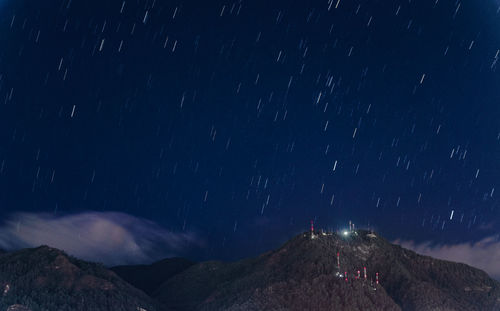 Scenic view of mountains against sky at night