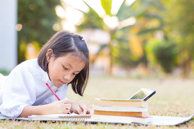 Close-up of a girl with book on table