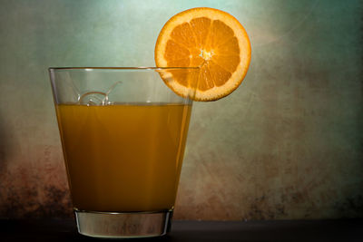 Close-up of orange juice in glass on table