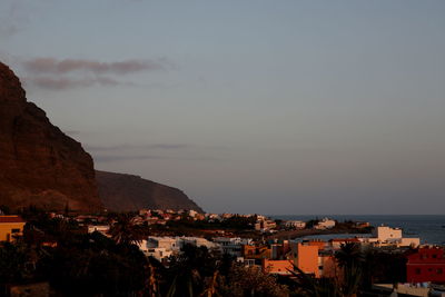 High angle view of townscape by sea against sky