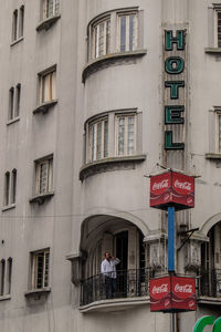 People walking on street against building in city