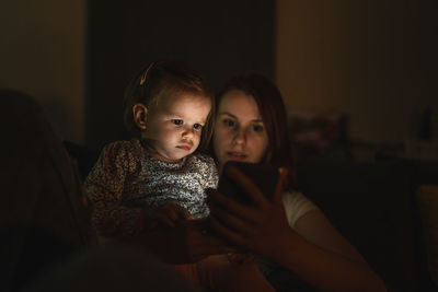 Portrait of cute girl sitting at home