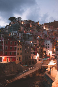 Buildings in town against sky at dusk