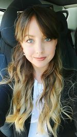 Portrait of young woman in car