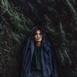 Portrait of beautiful young woman in forest