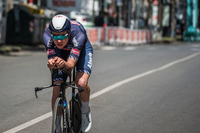 Man riding bicycle on road