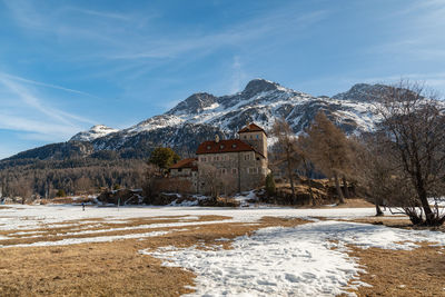 Silvaplana,switzerland, february 21, 2023 historic old castle crap da sass at the lake of silvaplana