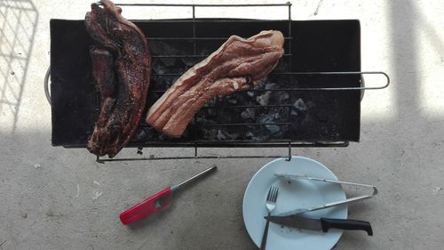 Directly above shot of meat on barbecue grill