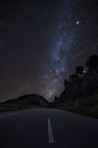 Scenic view of road against sky at night