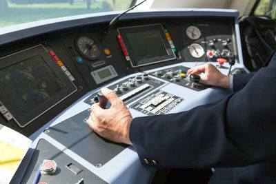 Cropped image of driver in train control room