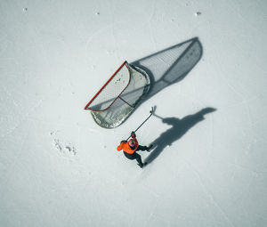 Drone view of man playing hockey ice