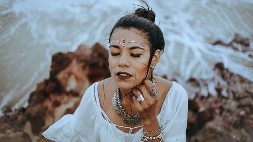 Woman with make-up against sea