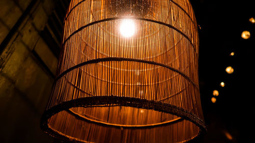 Low angle view of illuminated lamp at night