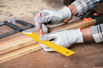 Cropped hand of man working at workshop