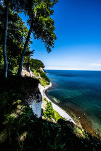 Scenic view of sea against blue sky