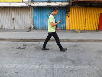 Side view of man walking on street