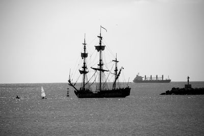 Ships moving on sea against clear sky