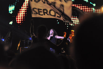 People photographing illuminated music concert at night