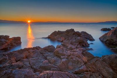 Scenic view of sea against sky during sunset