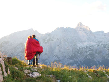 Couple enjoying the sunset in the alps