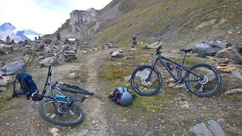 Bicycles on rock against sky