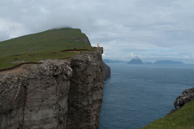 Scenic view of sea and mountains against sky