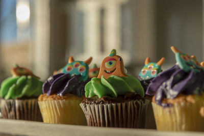Low angle close-up view of halloween cupcakes candy cakes