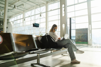 Side view of woman sitting in gym