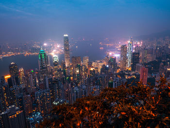 High angle view of illuminated buildings against sky at night