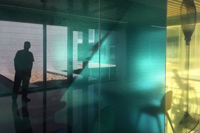 Reflection of man on glass window