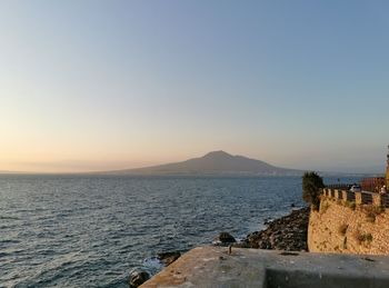 Scenic view of sea against clear sky during sunset