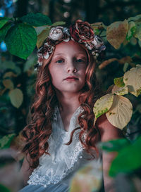 Portrait of young woman with plants