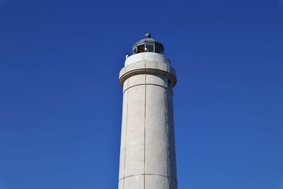 Low angle view of lighthouse against clear blue sky