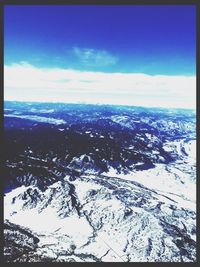 Scenic view of mountains against cloudy sky