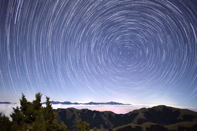 Scenic view of mountains against sky at night