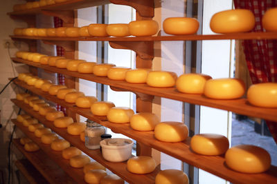 Close-up of cheese on shelves