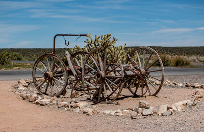 Bicycle parked on field against sky