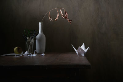 Paper crane and forced emigration. still life.