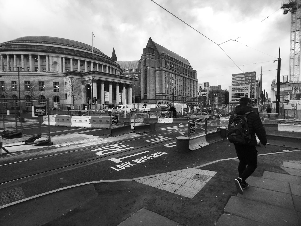 building exterior, architecture, built structure, city, sky, men, street, city life, transportation, lifestyles, walking, person, cloud - sky, road, incidental people, city street, leisure activity, travel